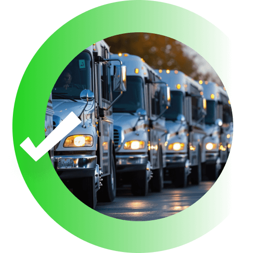 A line of trucks with headlights beaming