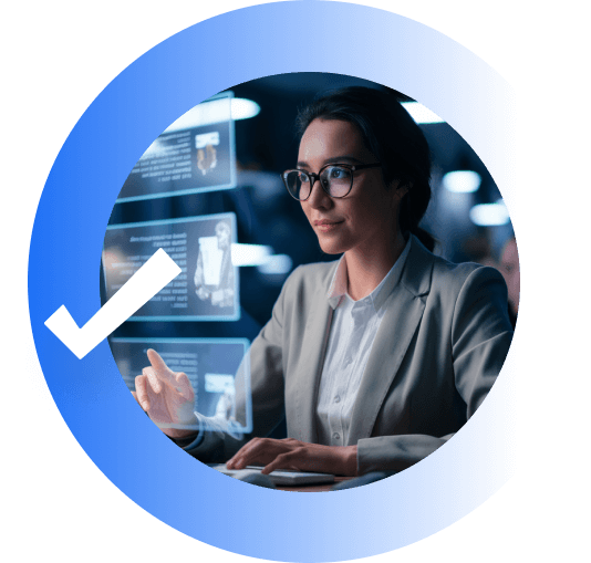 A woman smiling, wearing glasses and a grey blazer while scrolling through a hologram.