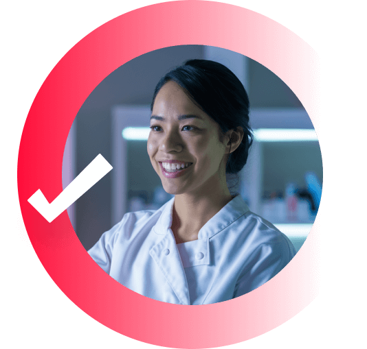 Lady smiling, wearing a white coat in a lab.