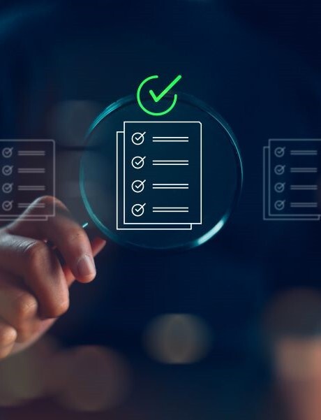 A magnifying glass held up against a holographic display of a checklist icon.