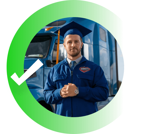 Driver posing in front a truck, wearing a graduation cap