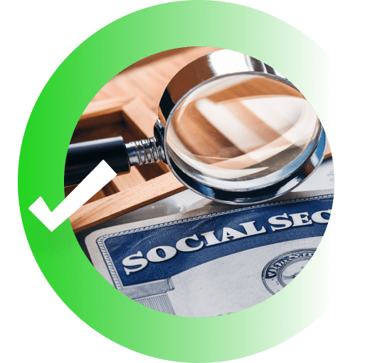A magnifying glass lying atop the corner of a Social Security Card