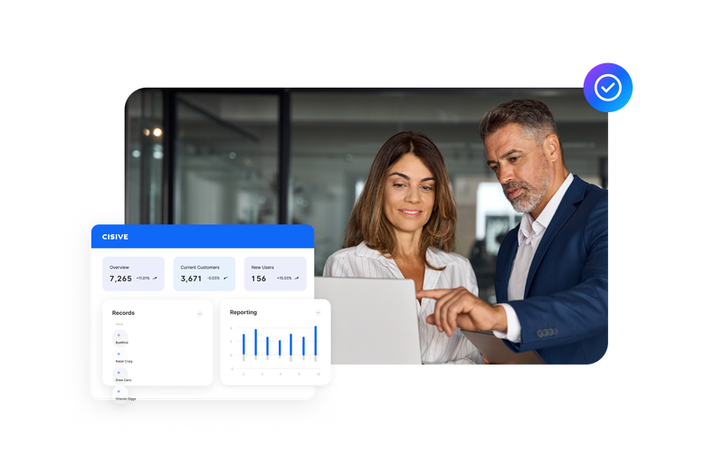 colleagues reviewing business performance dashboards together on a laptop