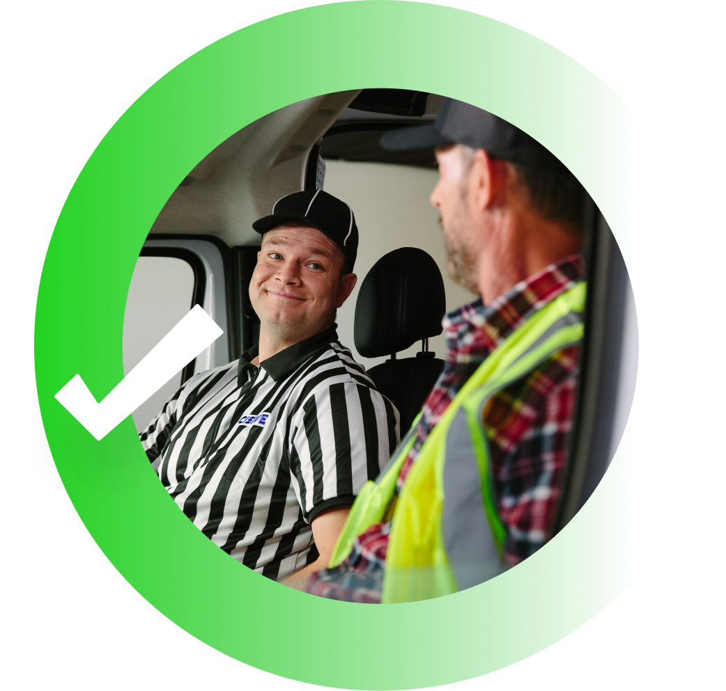 Cisive Coach smiling at a truck driver wearing a flannel and vest.